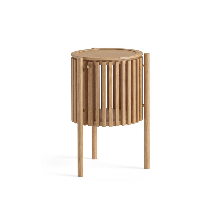 The Soho Story Side Table has curved slatted front with a door for storage. It has a blend of natural oak, oak veneers with a small gold door knob